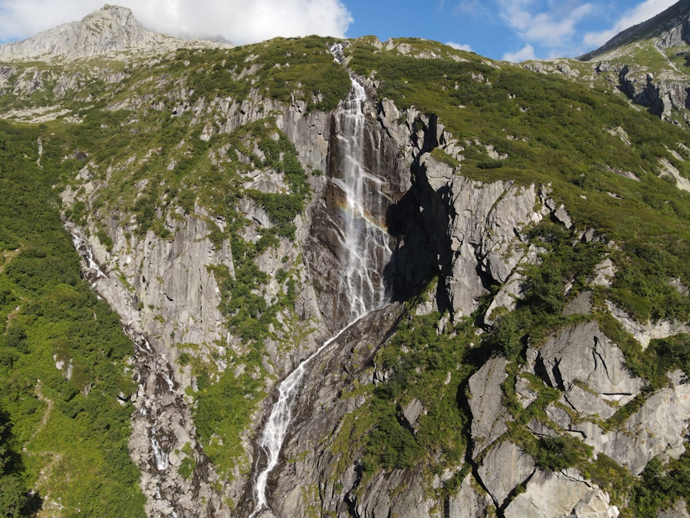 waterfalls on gray rocky mountain during daytime