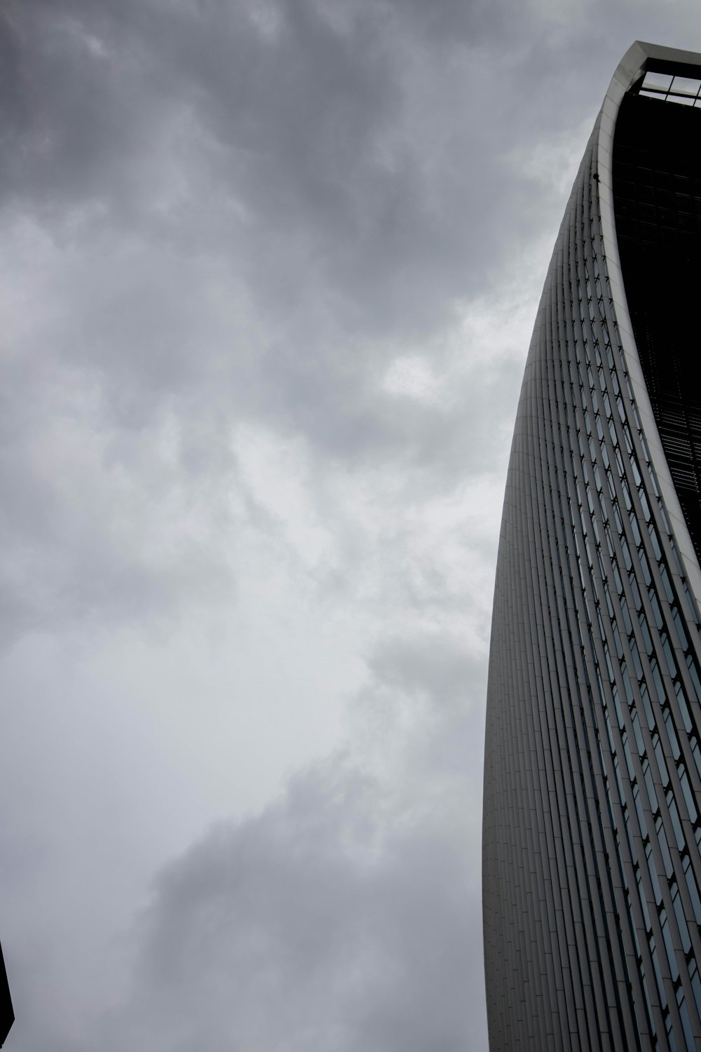 gray concrete building under white clouds during daytime