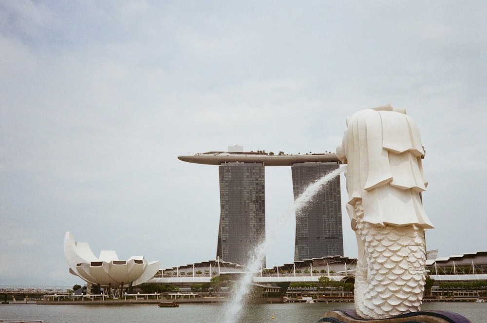 white concrete fountain under white sky during daytime