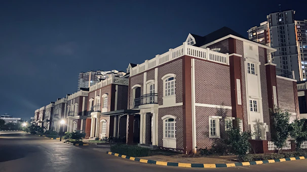 A completed residential neighborhood featuring brick houses with clean lines and landscaped yards.