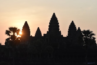 Photographer capturing sunrise over Luxor's ancient temple ruins.