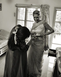 A friendly dhansaathi advisor assisting a middle-class Indian family with loan application paperwork in a bright, modern office.