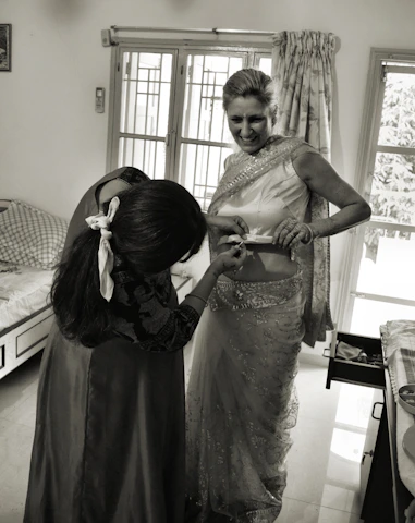 A friendly dhansaathi advisor assisting a middle-class Indian family with loan application paperwork in a bright, modern office.