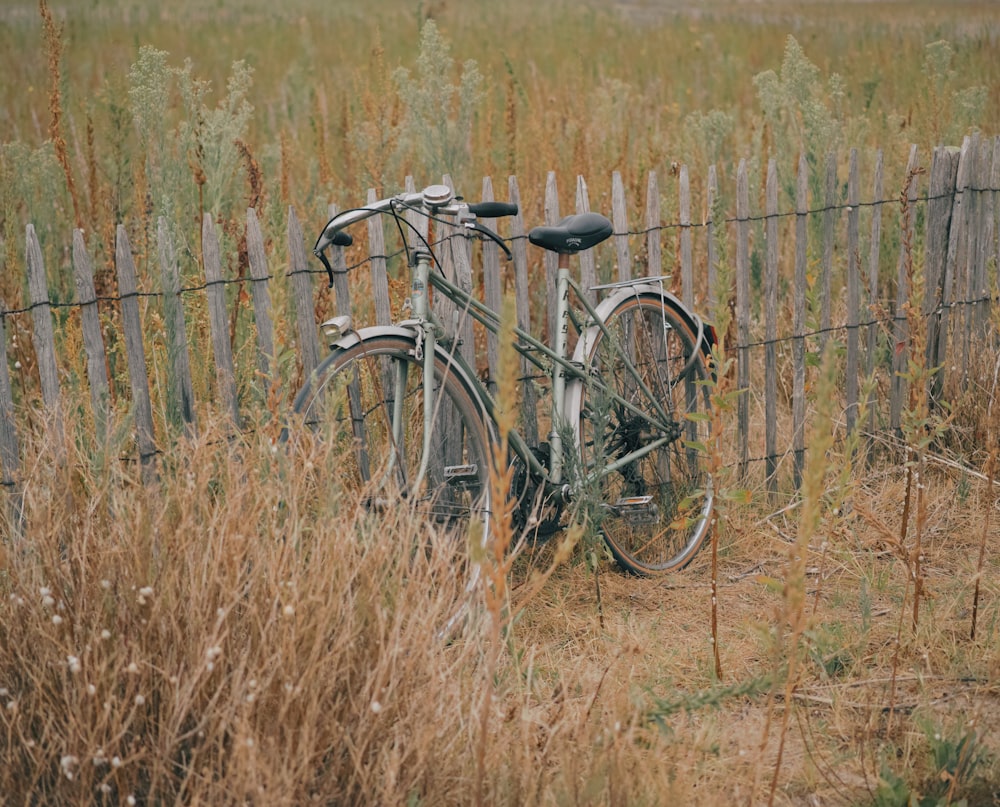 black bicycle on brown grass field during daytime