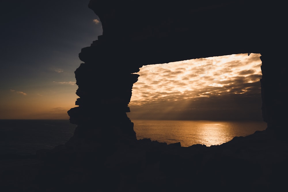 silhouette of rock formation during sunset