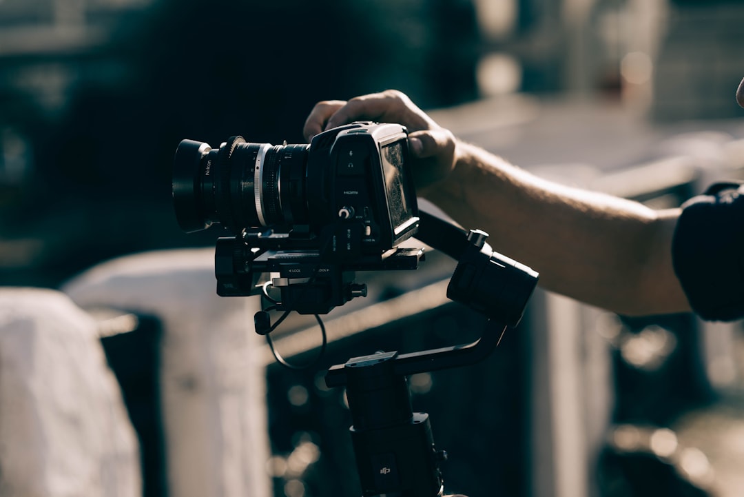 person holding black dslr camera