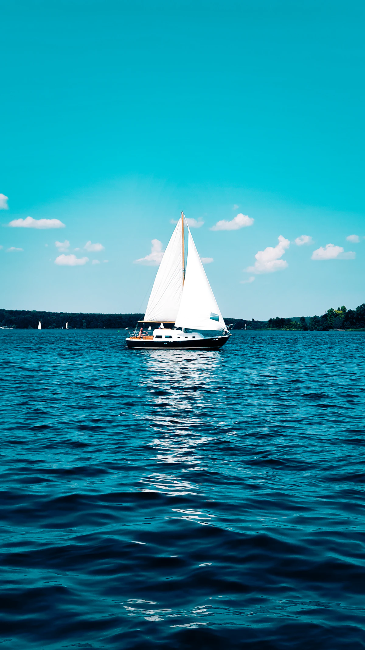 Aerial view of white sailboat sailing in the Mediterranean