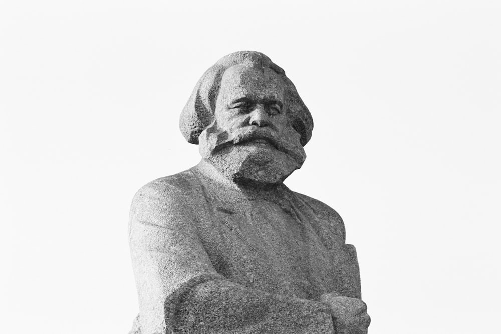 gray scale photo of man statue