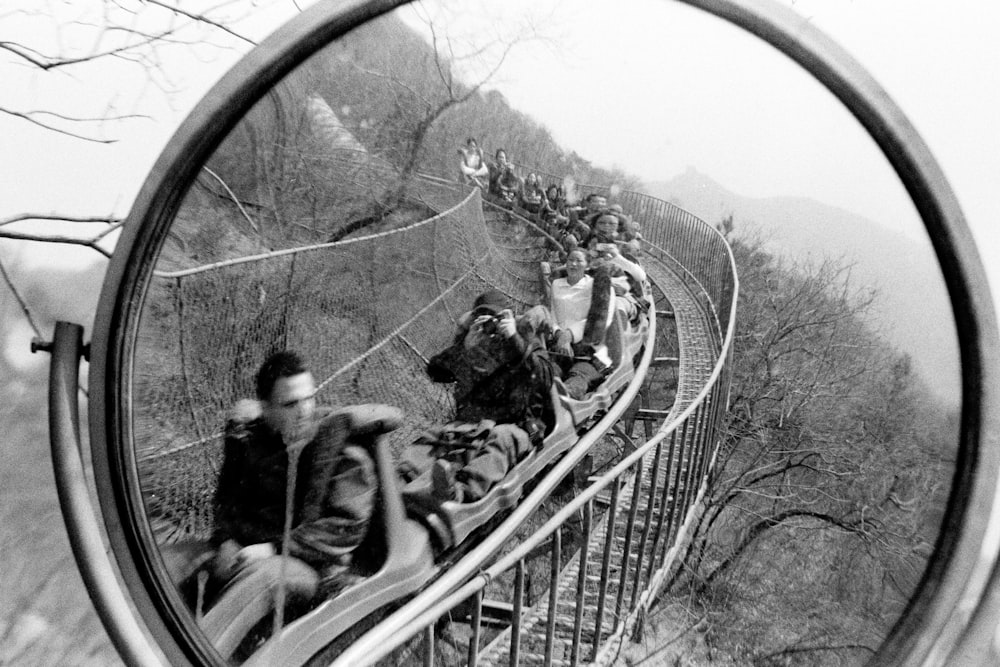 grayscale photo of people riding on bicycle