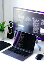 black and silver laptop computer beside black computer mouse