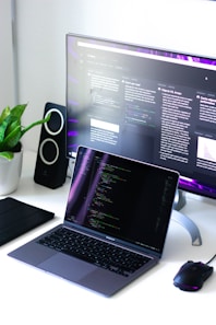 black and silver laptop computer beside black computer mouse