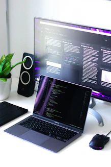black and silver laptop computer beside black computer mouse