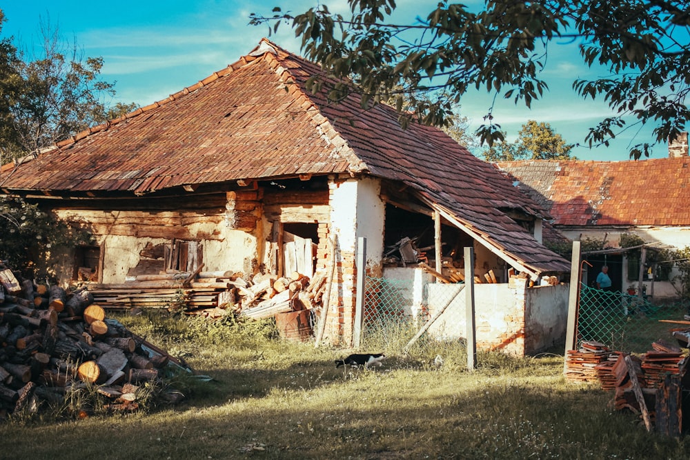 brown wooden house near green trees during daytime