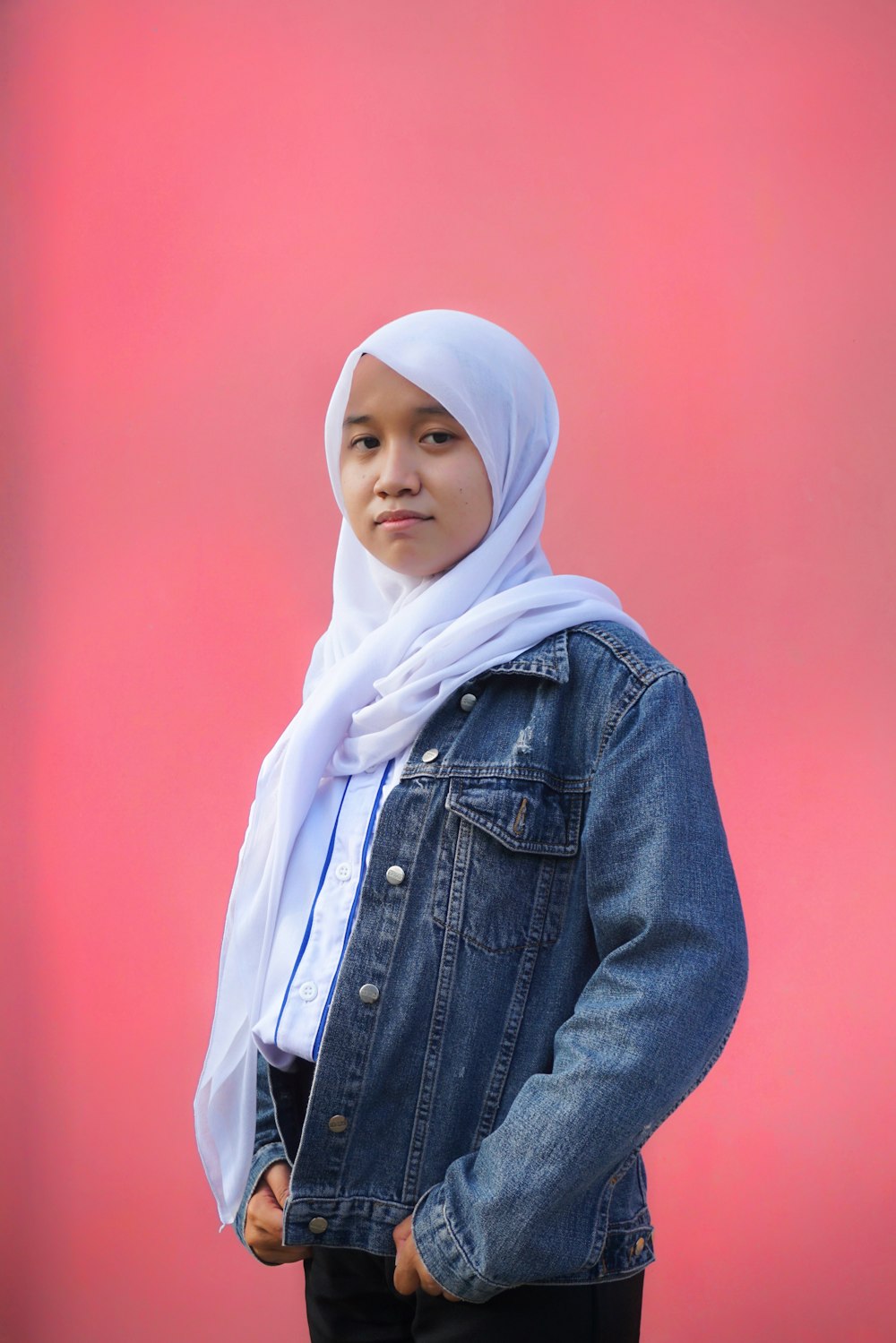 woman in blue denim jacket wearing white hijab