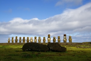 gray rock formation under white clouds and blue sky during daytime