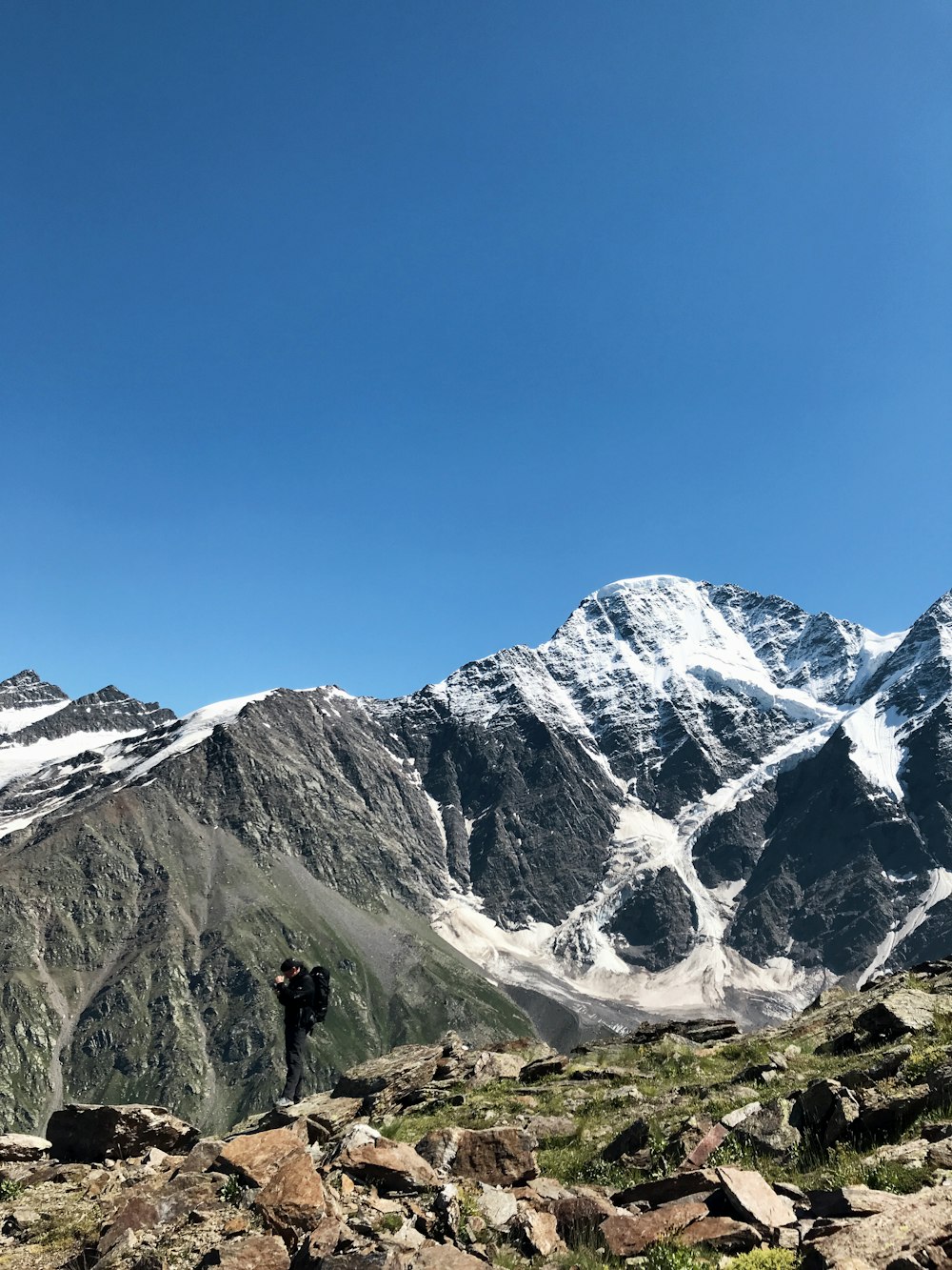 a couple of people standing on top of a mountain