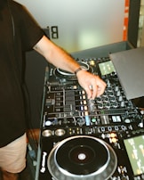 person in black t-shirt playing dj mixer
