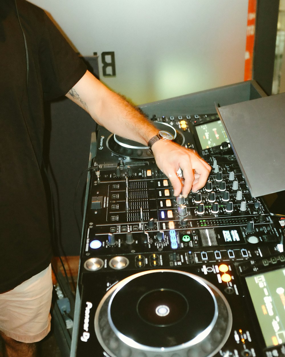 person in black t-shirt playing dj mixer