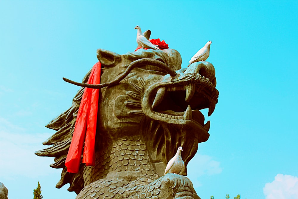 brown dragon statue under blue sky during daytime