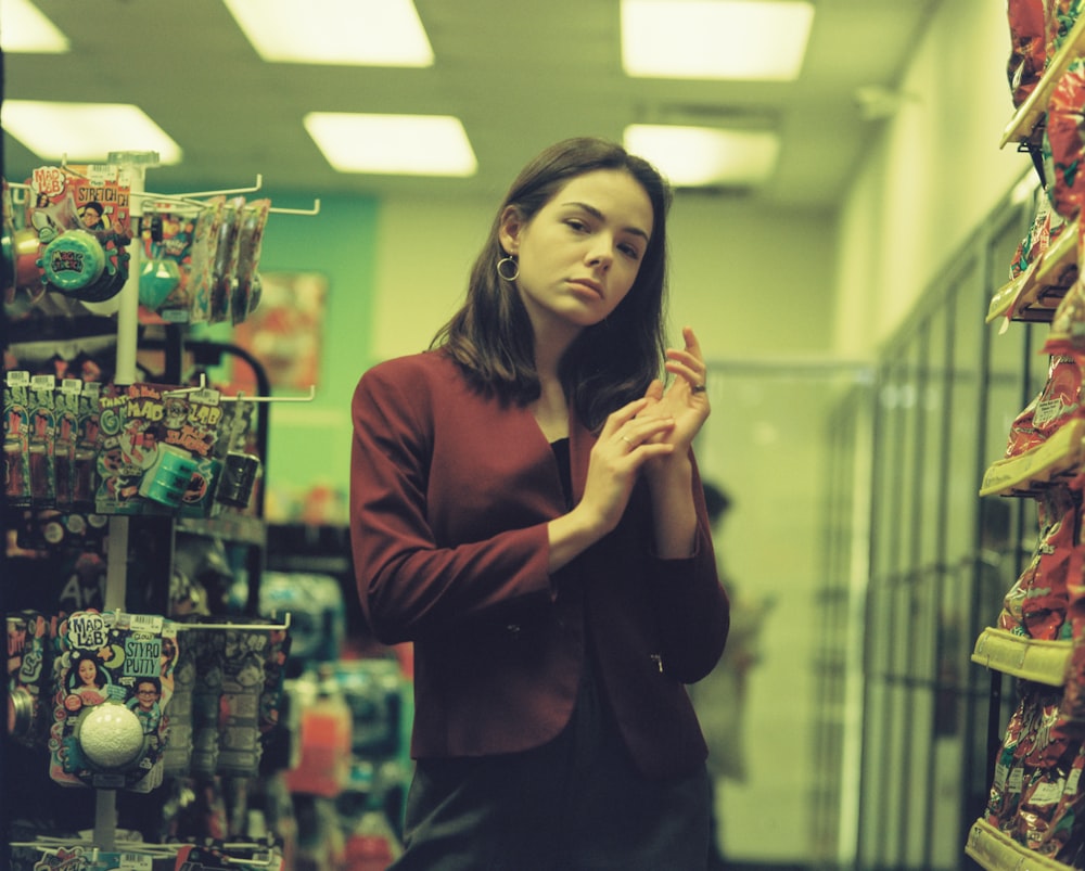 woman in brown long sleeve shirt standing near shelf