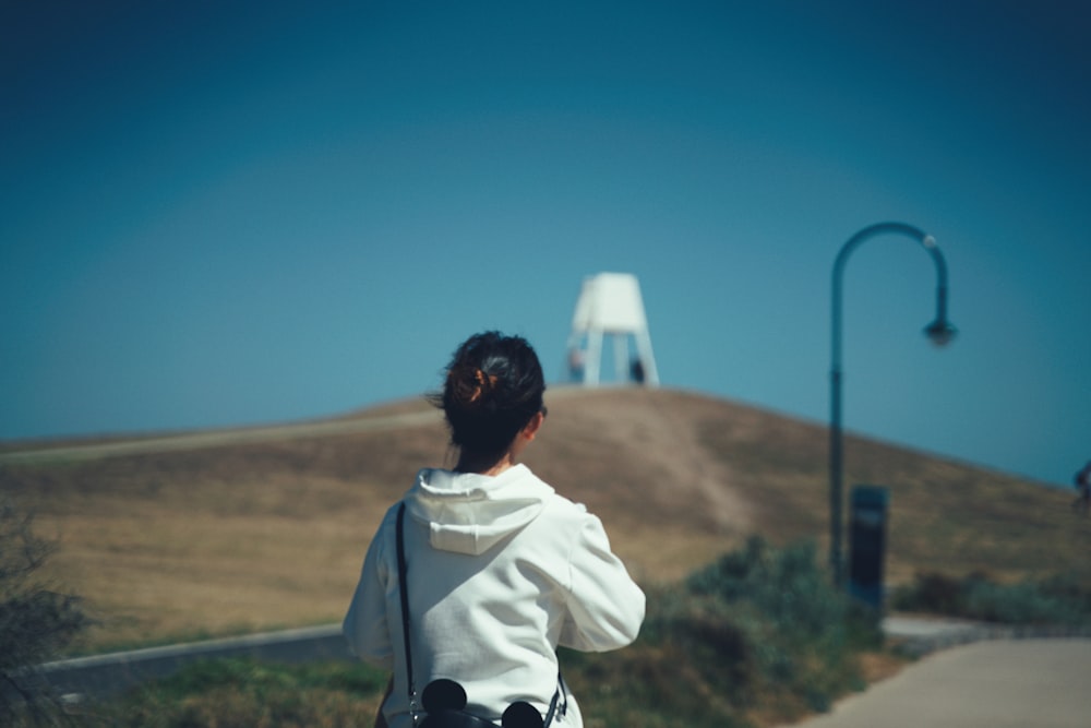 person in white jacket sitting on chair during daytime