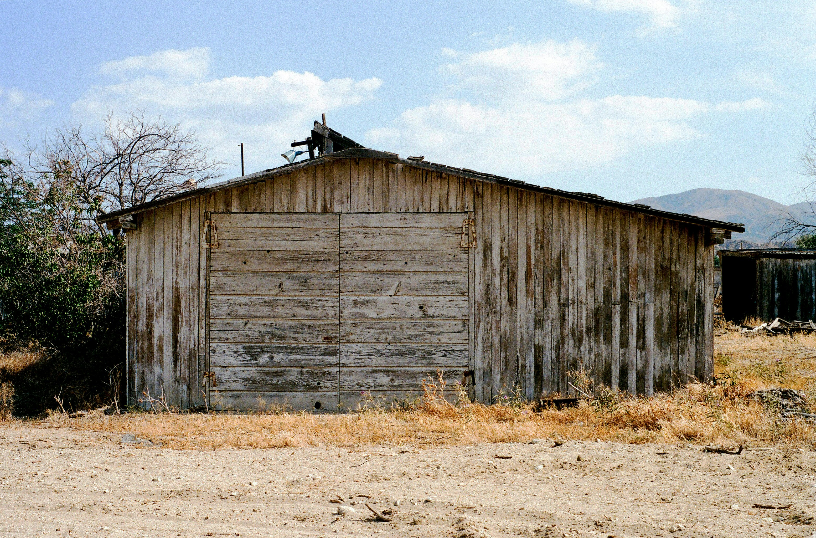 brown wooden barn under blue sky during daytime
