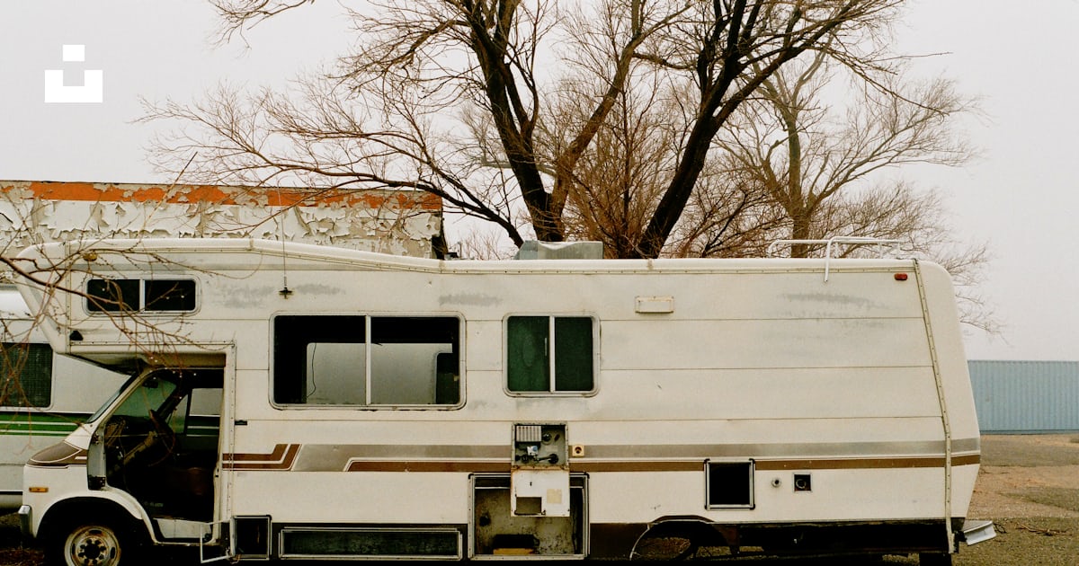 White and brown rv trailer on brown grass field during daytime photo ...