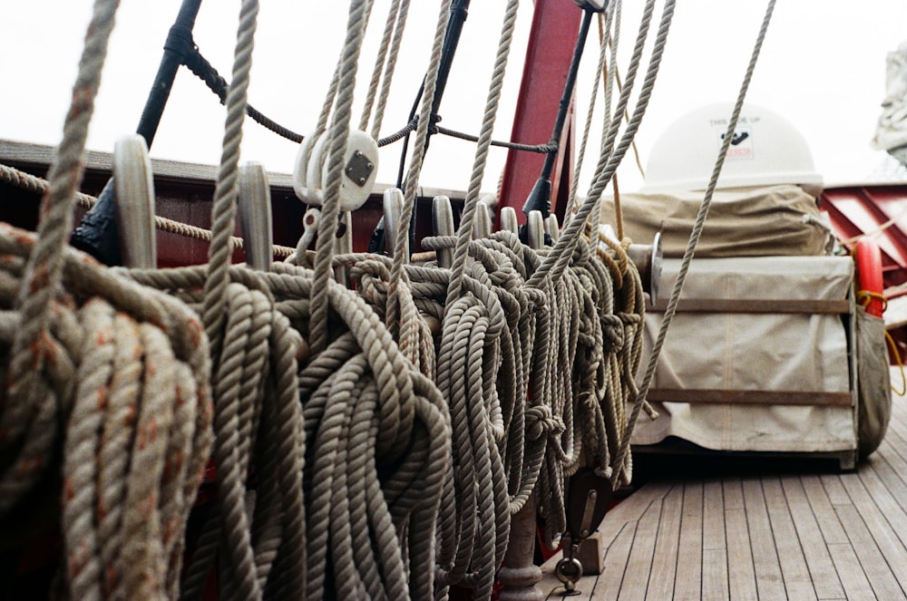 white and red boat on brown wooden dock during daytime