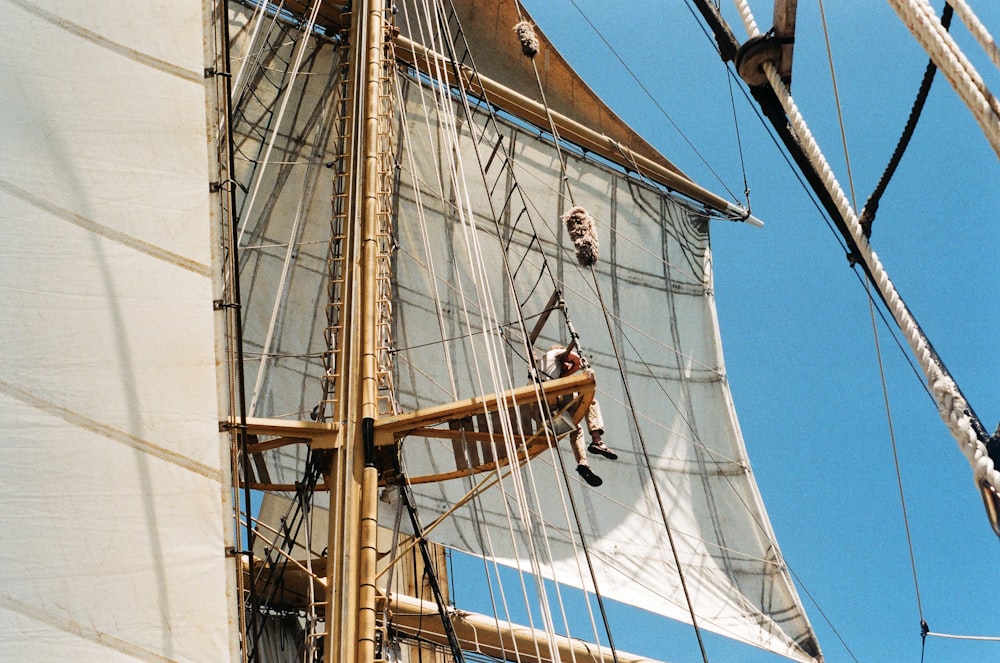 white and brown sail boat on water