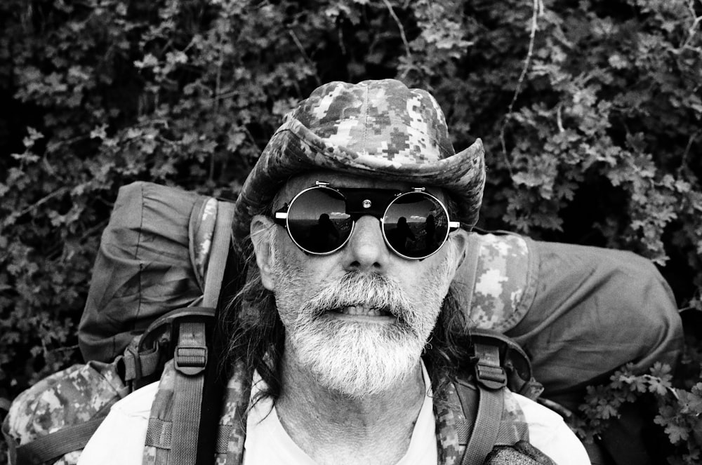 man wearing black sunglasses and brown hat