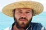 man in blue denim jacket wearing brown straw hat