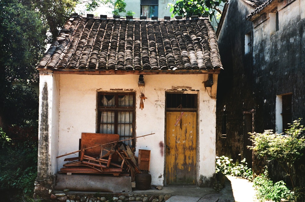 brown wooden bench beside yellow concrete house