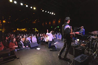 man in black jacket standing on stage