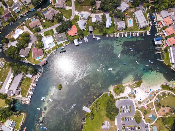 Street-level view of a Florida townhome community with a camera panning from right to left, showing the townhomes and nearby lake.