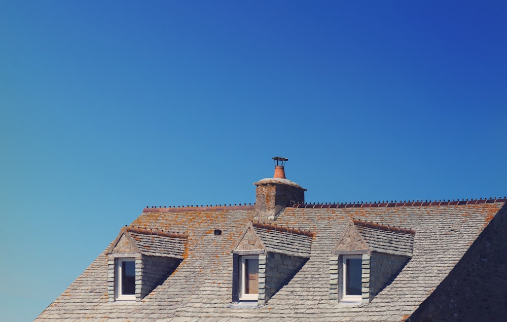 brown and white brick house under blue sky during daytime