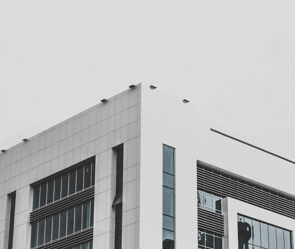 white concrete building with glass windows