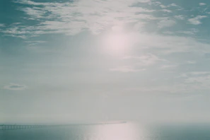 A serene view of the 25 de Abril Bridge stretching across the river in early morning light