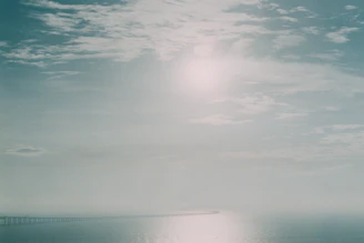 A serene view of the 25 de Abril Bridge stretching across the river in early morning light