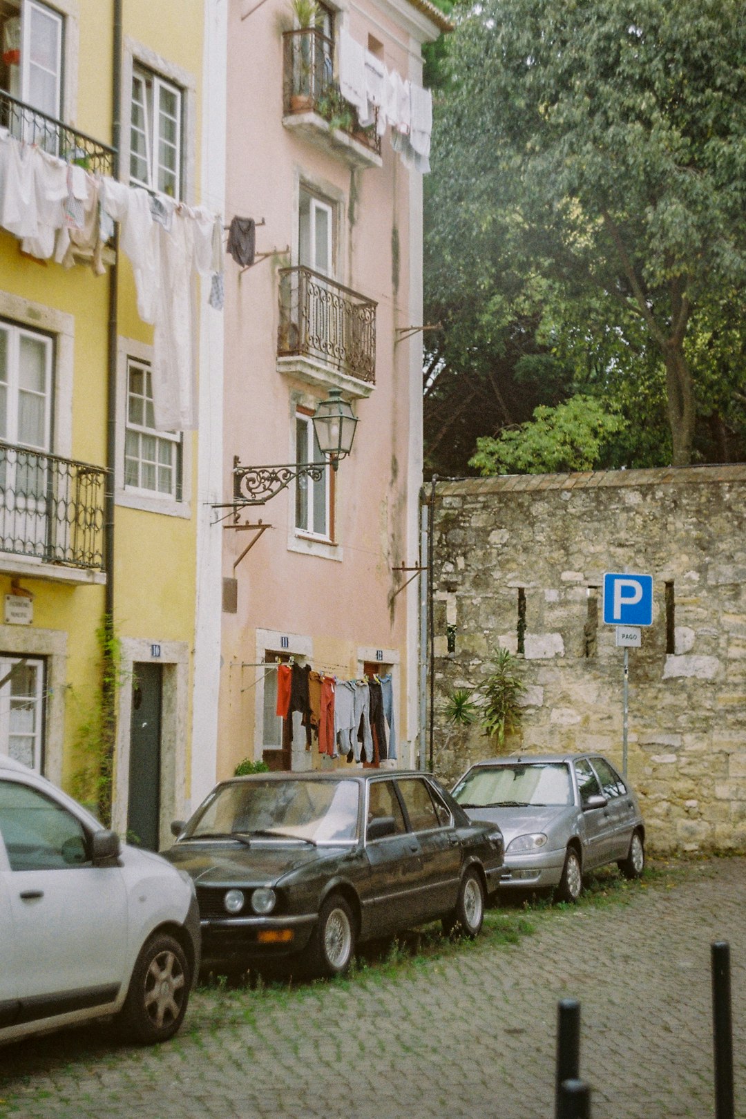 cars parked beside concrete building during daytime