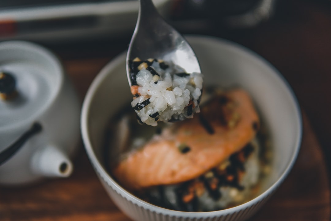 stainless steel spoon on brown pastry in white ceramic bowl