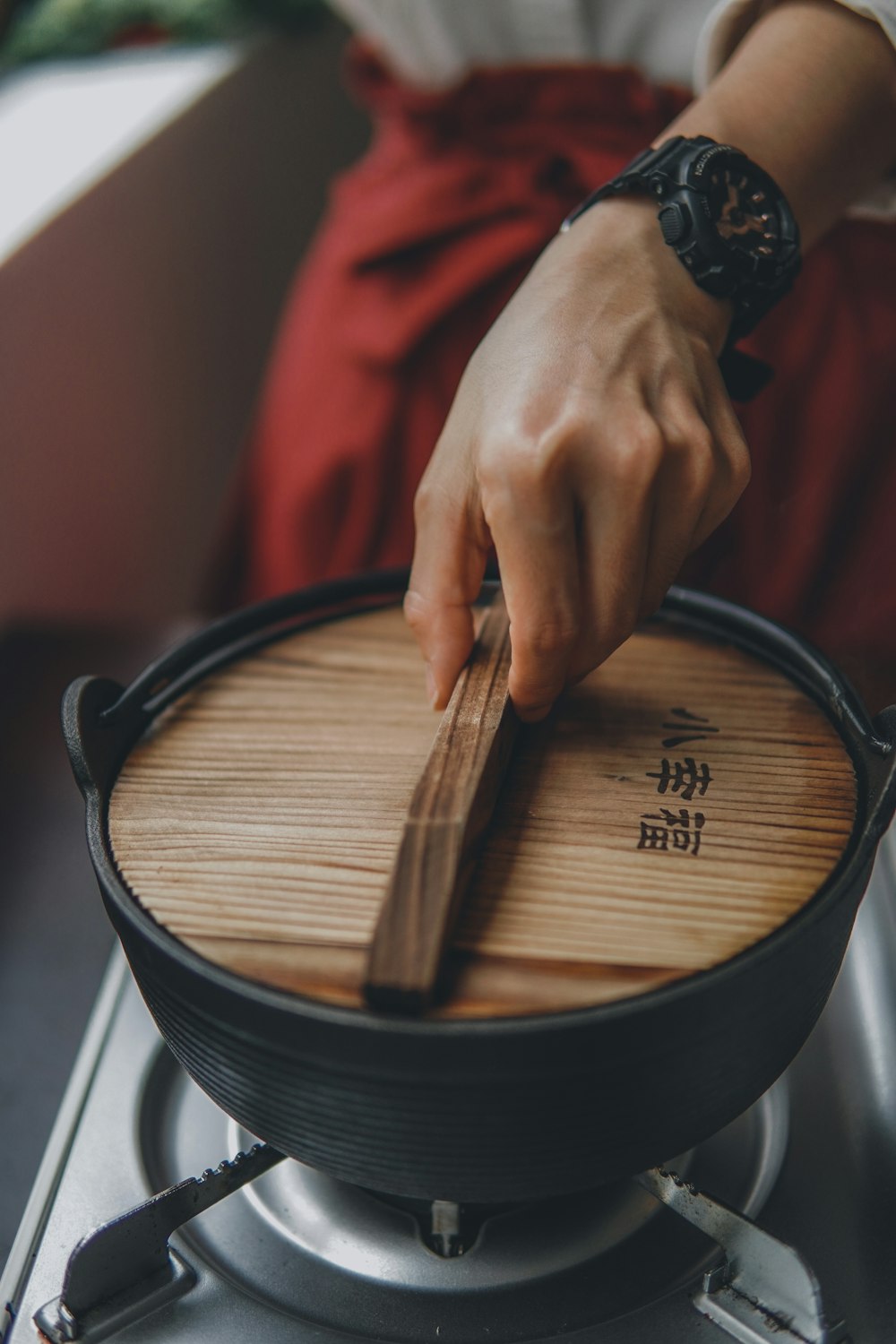 person holding brown wooden board