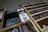 Wooden drawers filled with metal type pieces used for printing are organized in rows. There is a signboard with Chinese characters in the center and metal shelving visible.