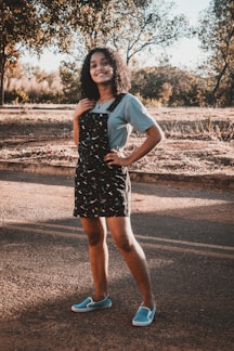 A model wearing a light summer dress in a sunny park.