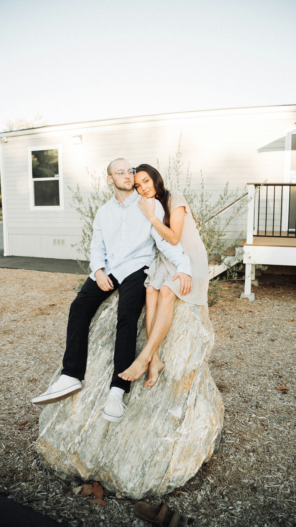 man and woman sitting on brown wooden bench during daytime