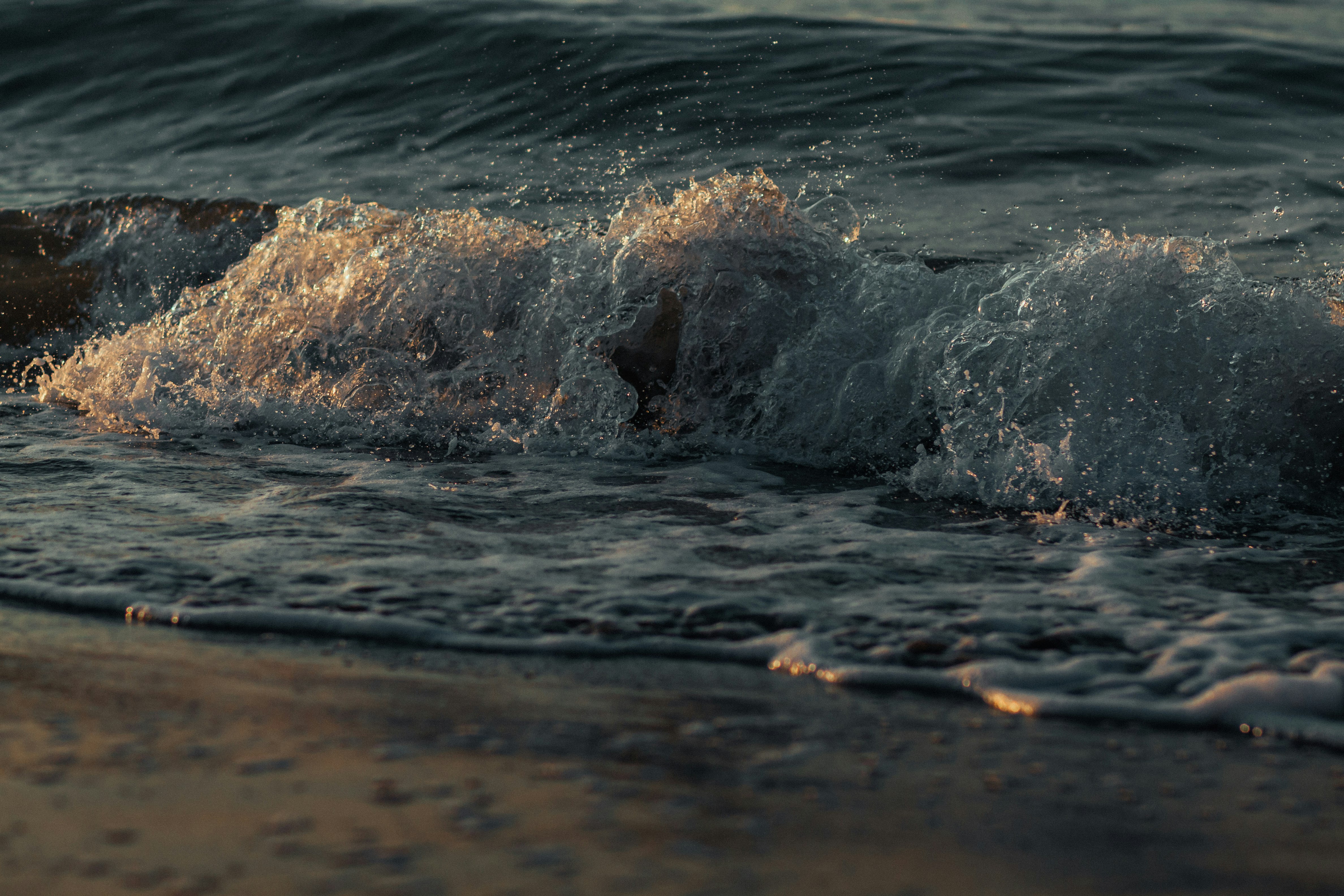 brown rock on body of water