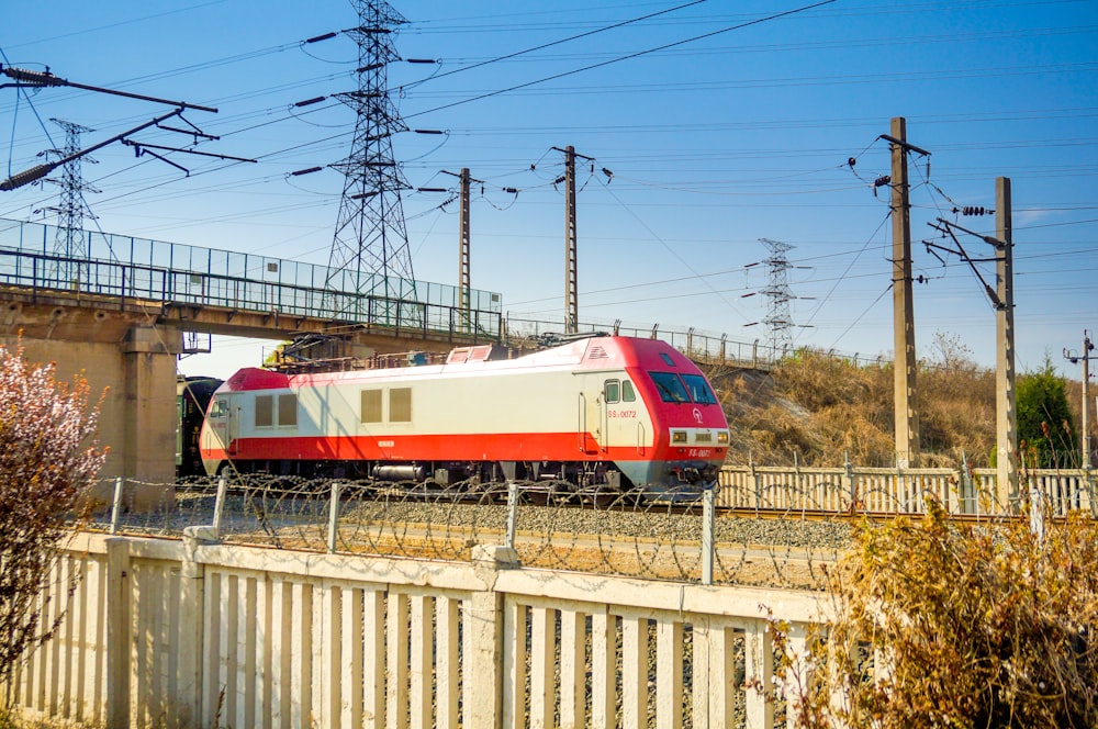 red and white train on rail tracks