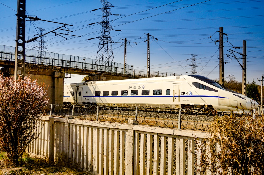 white train on rail tracks during daytime