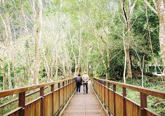 2 people walking on wooden bridge in Hualien City Taiwan