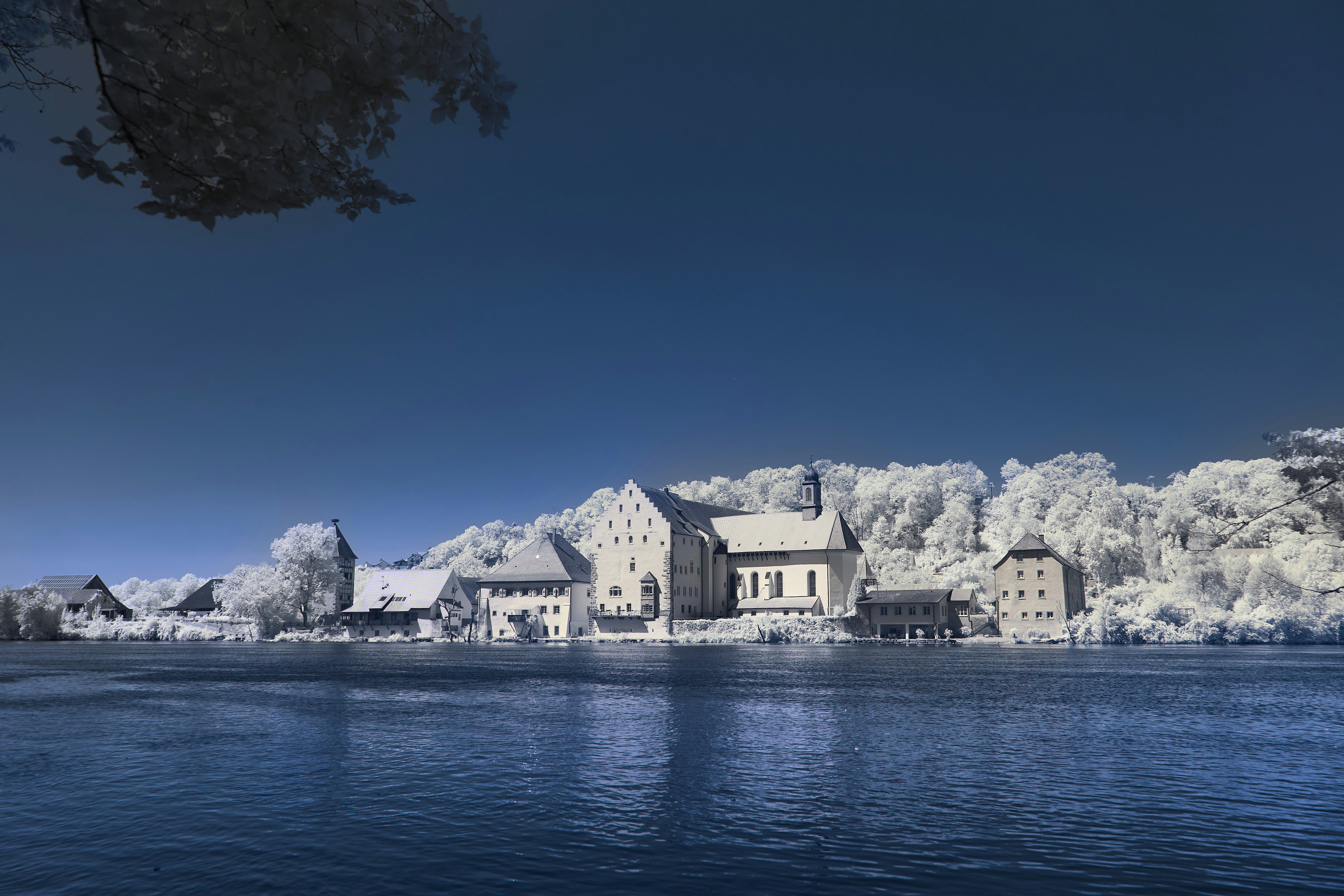 white and brown concrete houses near body of water during daytime