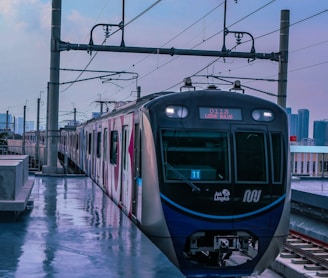 blue train on rail during daytime